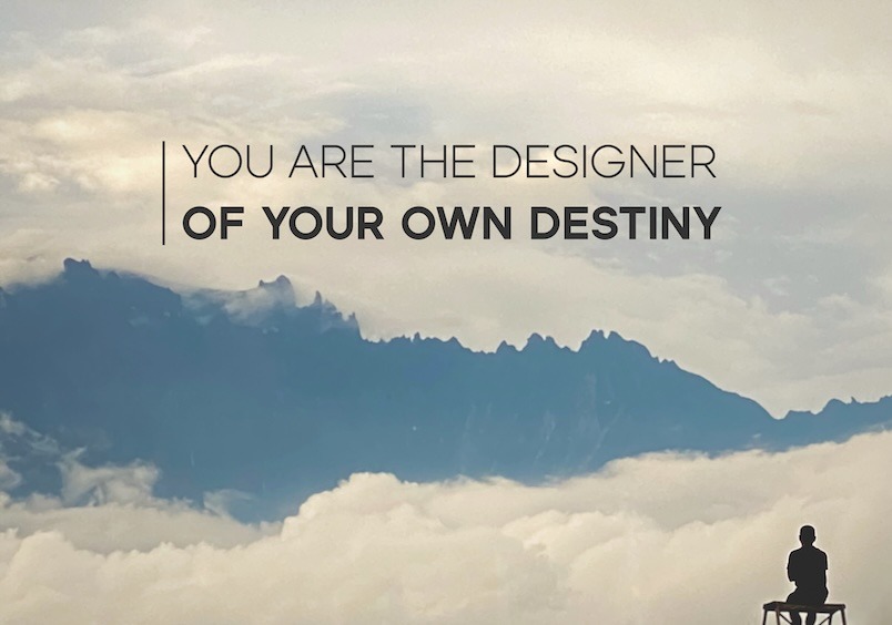 The words You are the designer of your own destiny are written in black over a photo of a mountain range visible above clouds. in the bottom right is the silhouette of a person sitting on a bench looking out towards the mountains.