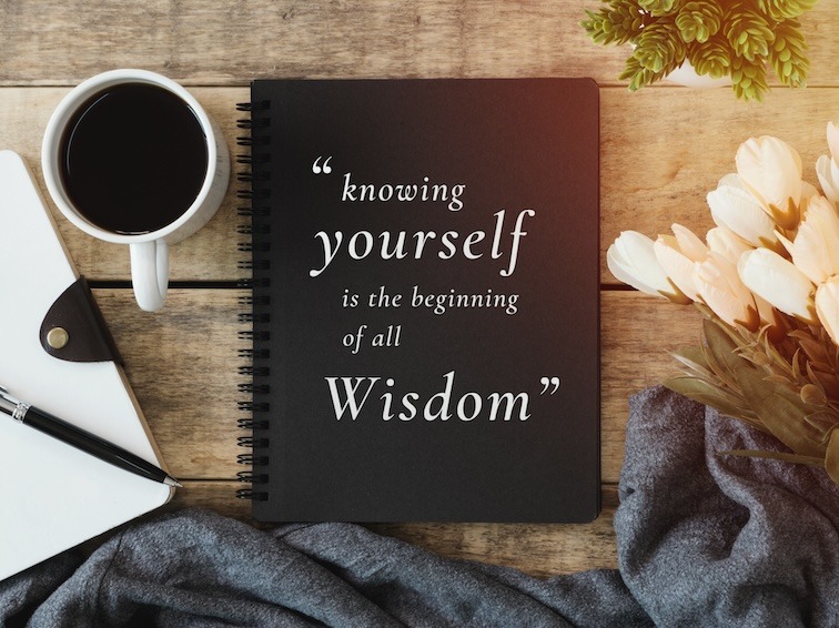 Photo of a black ring-bound book with the quote