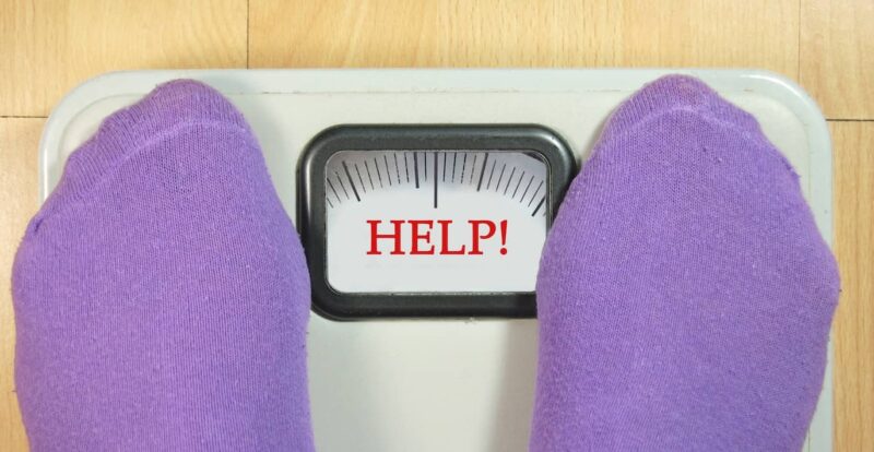 Standing on scales, struggling to lose weight