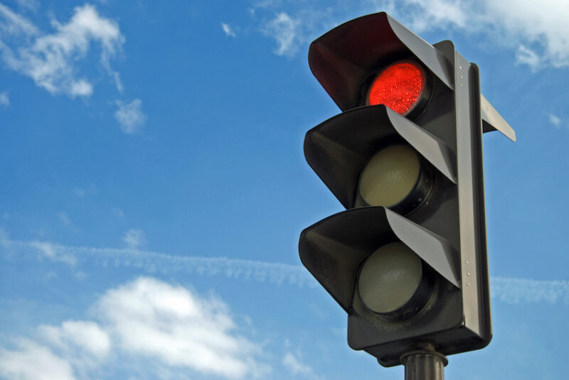 An image of a red stop light to depict pain and what is pain stopping you from doing. This blog article will explain an important factor that is often overlooked in the treatment process.