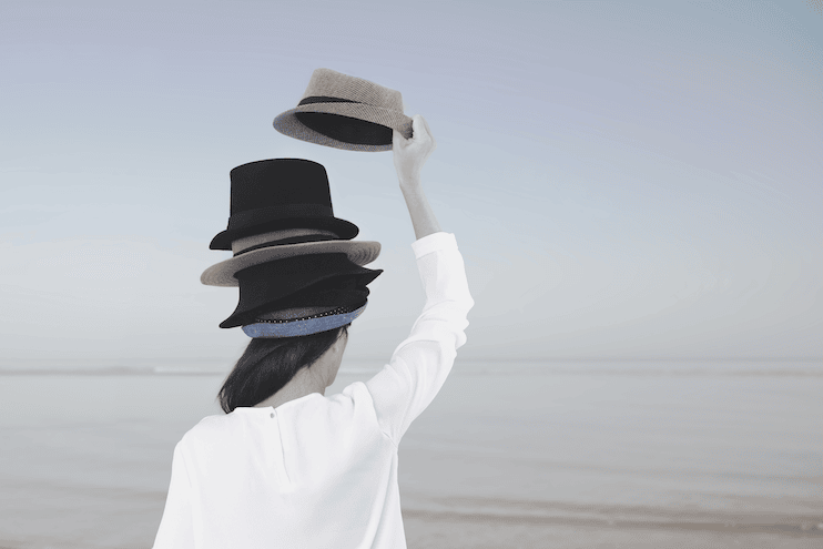 woman with multiple hats on to represent the different personas we take on